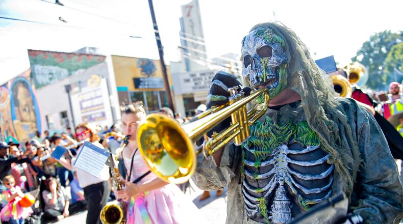 Christopher Manson (right) plays the trumpet as he marches in the 14th annual Little 5 Points Halloween Parade in Atlanta in 2014. Thousands of people lined the streets to watch the parade which featured local haunted attractions, bands and floats.