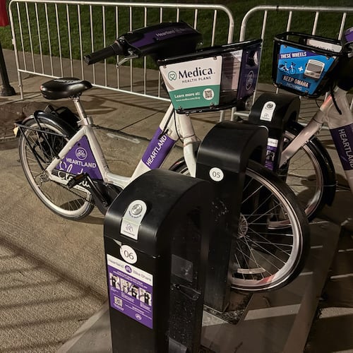 Omaha's Heartland Bike Share program places 400 e-bikes, such as this one, across the metropolitan area for public use. It is free for residents of metropolitan Omaha and a small charge for out-of-town sports columnists. (Ken Sugiura/AJC)