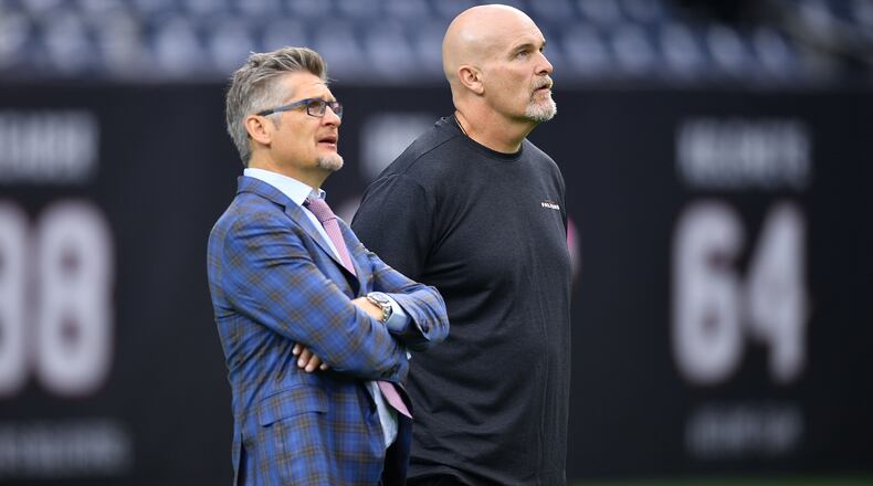 Falcons general manager Thomas Dimitroff and head coach Dan Quinn speak on the field prior to the game against the Texas Oct. 6, 2019, at NRG Stadium in Houston.