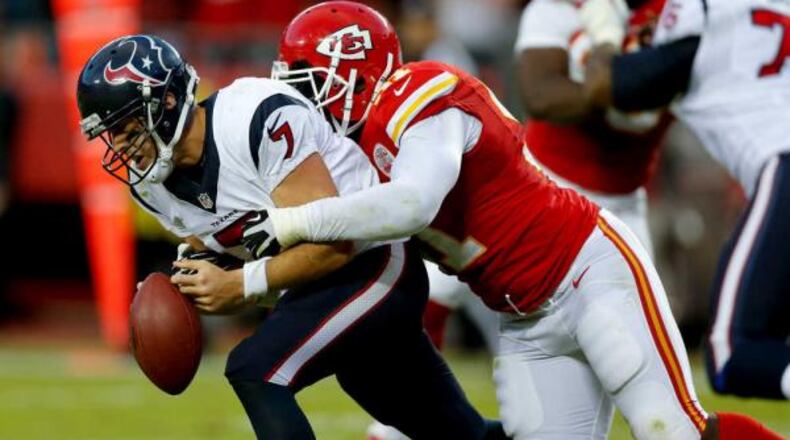 THE ASSOCIATED PRESS Kansas City linebacker Tamba Hali, right, forces Houston quarterback Case Keenum to fumble during the waning moments of Sunday's game at Arrowhead Stadium. Derrick Johnson recovered the fumble to seal the Chiefs' 17-16 victory, their seventh straight to open the season.