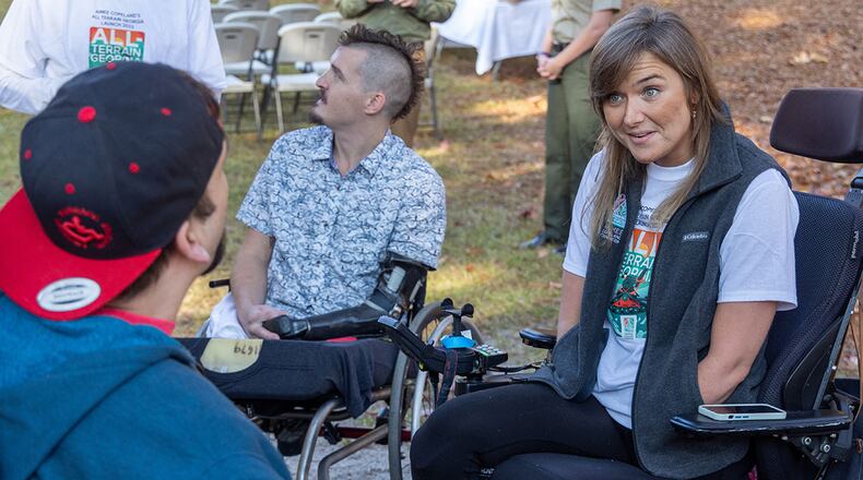 Aimee Copeland (right) spoke with Ben Oxley before a ceremony where All Terrain Georgia, an initiative of Aimee Copeland Foundation in partnership with Georgia Department of Natural Resources, introduces the all-terrain chairs they provide to enable the mobility impaired to get out in nature. One of the Action Trackchairs was available to try out at a Panola Mountain State Park after the ceremony. PHIL SKINNER FOR THE ATLANTA JOURNAL-CONSTITUTION