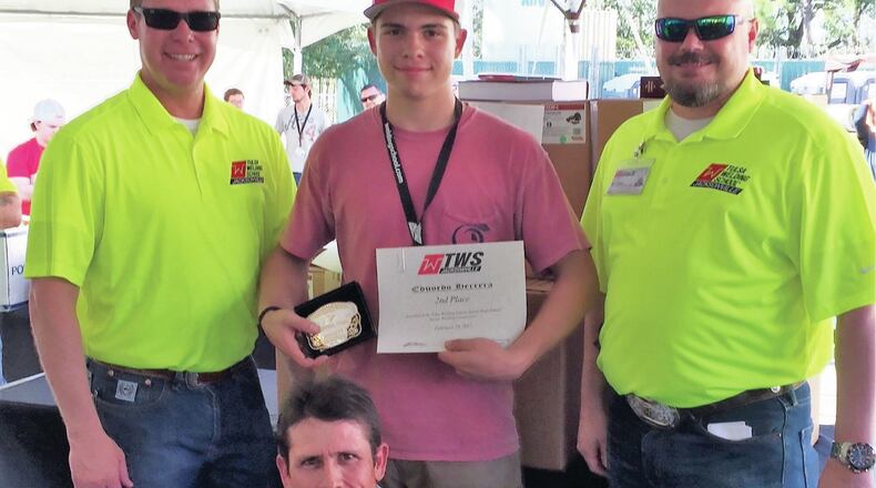 Cherokee High School senior Ed Herrera, who is pictured with his father, front row, and Tulsa Welding School representatives. He placed second in the national competition and earned a $9,000 scholarship, welding equipment and tools and a champion buckle.