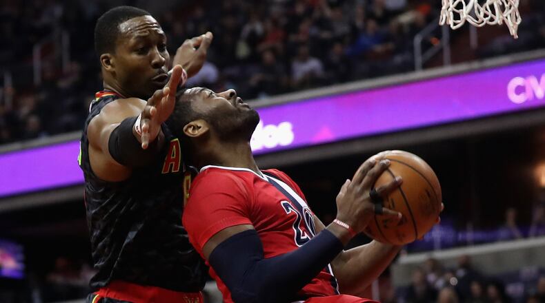 John Wall of the Washington Wizards puts up a shot in front of Dwight Howard of the Atlanta Hawks during the first half at Verizon Center on March 22, 2017 in Washington, DC. (Photo by Rob Carr/Getty Images)