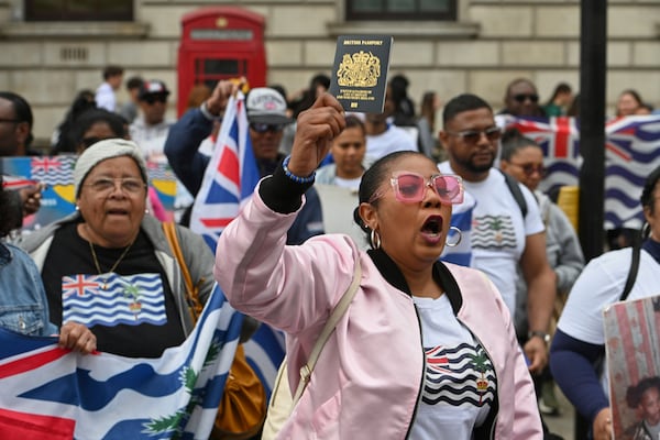 People demonstrate outside the Foreign Office in London, Thursday, May 22, 2025, after a British court blocked the U.K. from transferring sovereignty over the Chagos Islands to Mauritius hours before the agreement was due to be signed. (AP Photo/Thomas Krych)