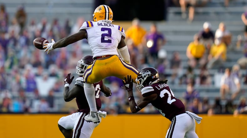 LSU tight end Arik Gilbert (2) tries to pull in a pass against Mississippi State safety Dylan Lawrence (24) and safety Tyrus Wheat. (AP Photo/Gerald Herbert)