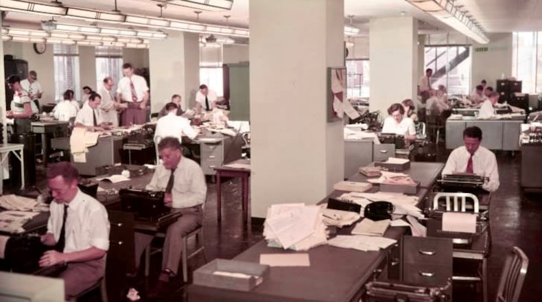 Reporters crank out copy in 1950 in the Atlanta Constitution newsroom. Longtime reporter/columnist Celestine Sibley composes something, mid-right of photo. (credit: AJC archives)