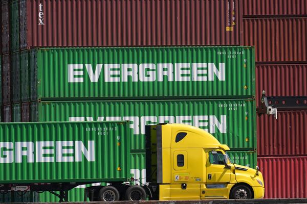 Containers are stacked at the Port of Los Angeles Wednesday, April 2, 2025, in Los Angeles. (AP Photo/Damian Dovarganes)