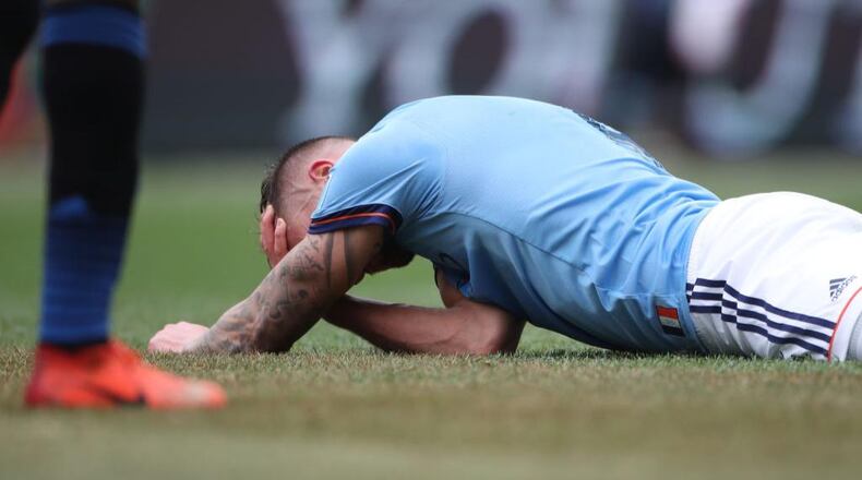 Maxime Chanot of New York City FC holds his head after a clash of heads form a corner kick during a game last year. Researchers say even mild concussions can increase risks for dementia.