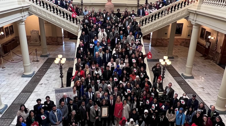 Immigrant advocates pose with Gov. Brian Kemp and Georgia first lady Marty Kemp at the Georgia Capitol on Tuesday, February 14 2023. (Photo courtesy of the Coalition of Refugee Service Agencies)