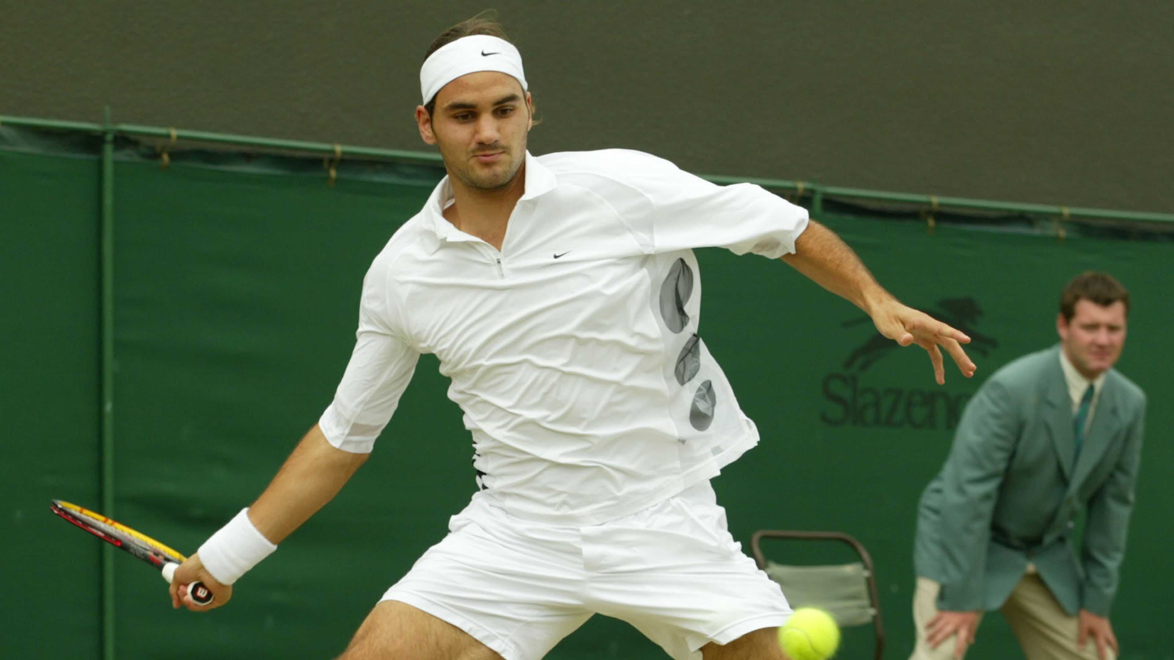FILE - Switzerland's Roger Federer plays a return to Sjeng Schalken, of the Netherlands, during their men's singles quarter final match at the All England Lawn Tennis Championships at Wimbledon, July 3, 2003. (AP Photo/Alastair Grant, File)