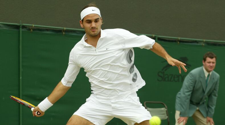 FILE - Switzerland's Roger Federer plays a return to Sjeng Schalken, of the Netherlands, during their men's singles quarter final match at the All England Lawn Tennis Championships at Wimbledon, July 3, 2003. (AP Photo/Alastair Grant, File)