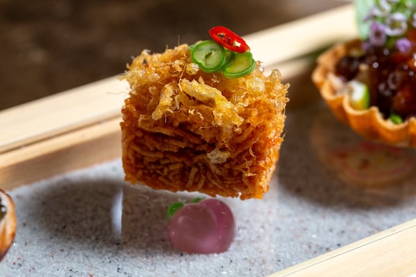 A bite-sized Thai coconut pancake topped with caviar.