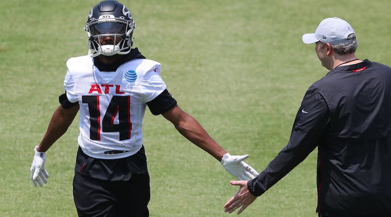Falcons wide receiver Russell Gage (14), wearing a new jersey number, is congratulated by head coach Arthur Smith after catching a pass during organize team activities (OTAs) Tuesday, May 25, 2021, at the team training facility in Flowery Branch. (Curtis Compton / Curtis.Compton@ajc.com)