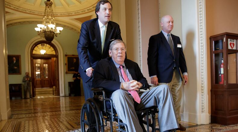 Sen. Johnny Isakson, R-Ga., is wheeled away from the Senate chamber on March 30, 2017. (AP Photo/J. Scott Applewhite)