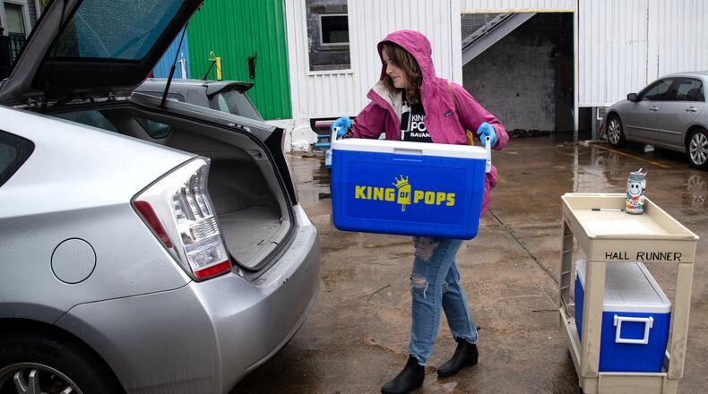 King of Pops Atlanta Territory Operations Manager Alice Diekhoff loads up the car she will use to make her home deliveries at their headquarters on March 23, 2020. King of Pops started home delivery last Wednesday as the coronavirus continued to ravage the state. STEVE SCHAEFER / SPECIAL TO THE AJC