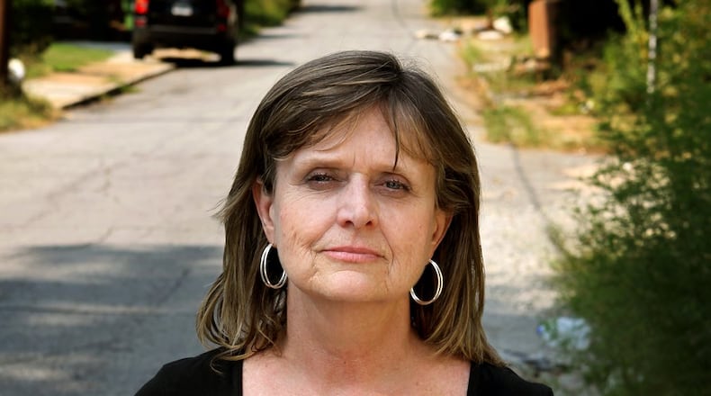 Robin Elliott holds a photograph of her late 21-year-old son, Zack Elliott, who was found dead in his automobile of a drug overdose in 2011. (AJC File Photo)