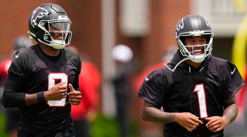 Atlanta Falcons quarterback's Michael Penix Jr. and Tua Tagovailoa (1) move during an NFL football practice, Wednesday, May 27, 2026, in Flowery Branch, Ga. (AP Photo/Mike Stewart)