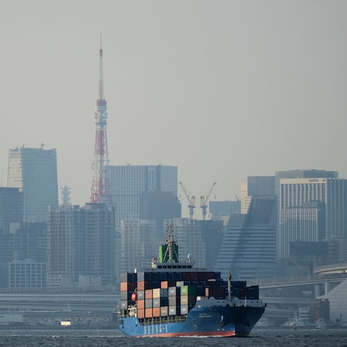 Tokyo Tower is seen amid tall buildings as a container ship leaves a cargo terminal in Tokyo, April 9, 2025. (Hiro Komae/AP)