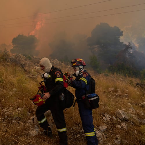 Firefighters operate on Mount Kithairon near Porto Germeno, northwest of Athens, Greece, Monday, Aug. 3, 2026. (AP Photo/Petros Giannakouris)