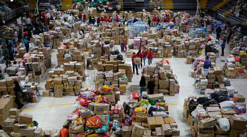 Volunteers sort aid bound for people affected by the earthquake in Choco department, in Bogota, Colombia, Tuesday, Aug. 18, 2026. (AP Photo/Fernando Vergara)