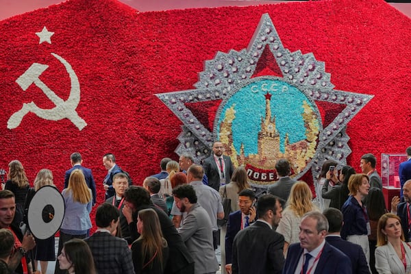 Guests and participants walk in front of a model of the Order of Victory on the sidelines of the St. Petersburg International Economic Forum in St. Petersburg, Russia, Wednesday, June 18, 2025. (AP Photo/Dmitri Lovetsky)