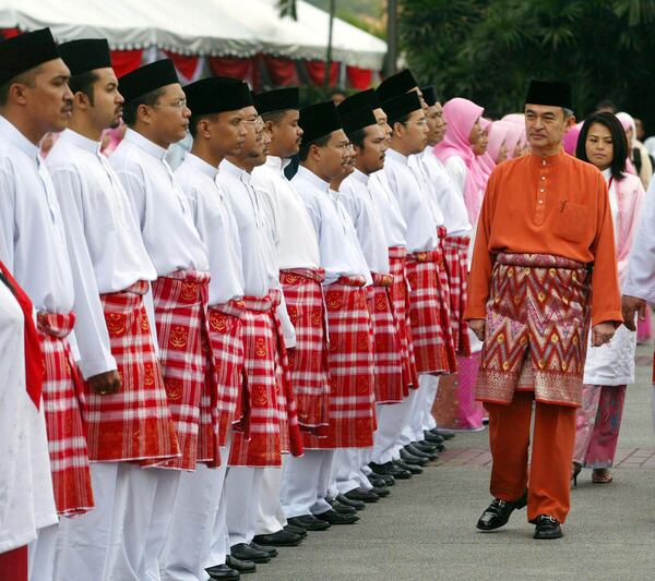 FILE - Malaysia's Prime Minister Abdullah Ahmad Badawi, right, inspects the members of youth wing of United Malays National Organization during the UMNO general meeting in Kuala Lumpur, Malaysia, Thursday, Sept. 23, 2004. (AP Photo/Vincent Thian, File)