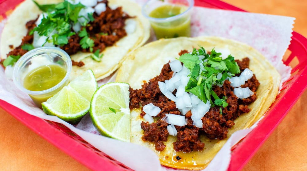 These chorizo tacos at Supermercado Chicago are dressed up with a few items from the salsa bar. CONTRIBUTED BY HENRI HOLLIS