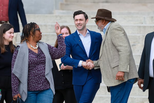 Democratic U.S. Sen. Jon Ossoff (center) greets State Rep. Dewey McClain (right), D-Lawrenceville, before speaking at a supporters rally near the Georgia state Capitol last month. (Jason Getz/AJC)