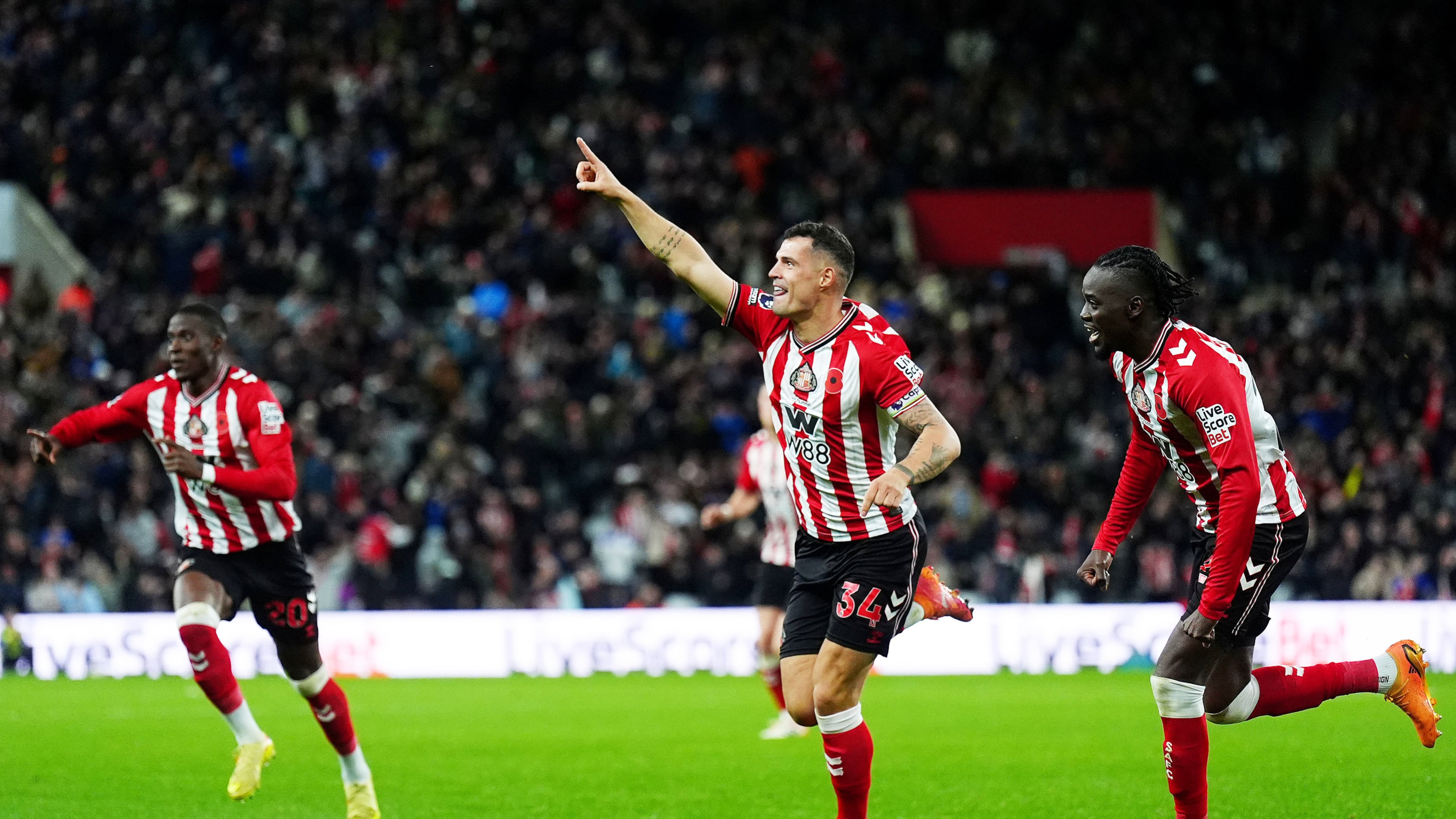 Sunderland's Granit Xhaka, center, celebrates scoring during the English Premier League soccer match between Sunderland and Everton in Sunderland, England, Monday Nov. 3, 2025. (Owen Humphreys/PA via AP)