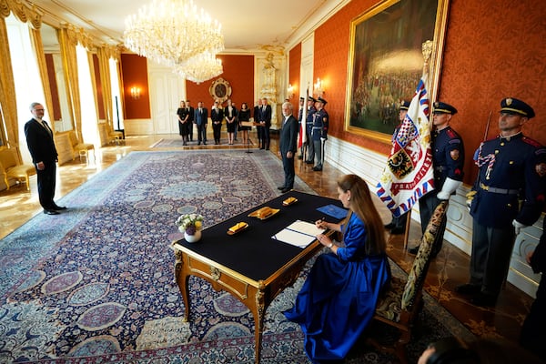 Eva Decroix signs an oath while being appointed as new Justice Minister at the Prague Castle in Prague, Czech Republic, Tuesday, June 10, 2025. (AP Photo/Petr David Josek)