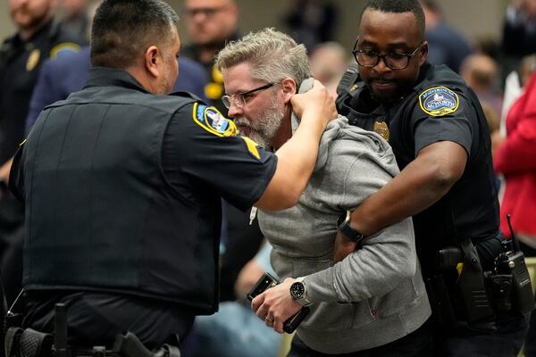 A protester is removed as Rep. Marjorie Taylor Greene, R-Ga., speaks during a town-hall style meeting, Tuesday, April 15, 2025, in Acworth, Ga. (AP Photo/Mike Stewart)
