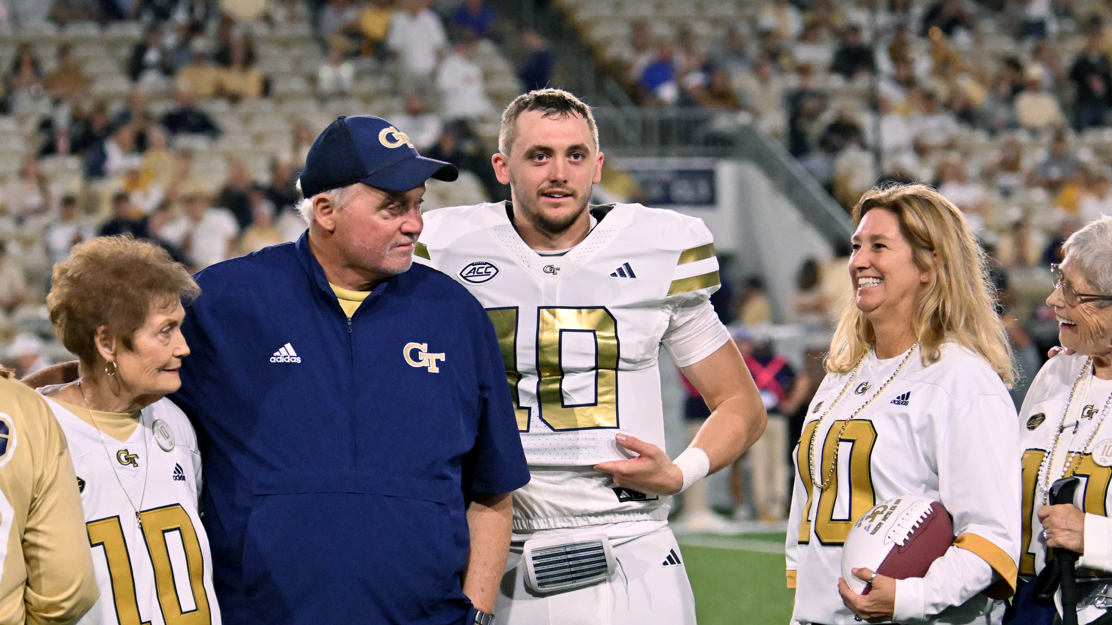 Georgia Tech quarterback Haynes King and his family react during a senior night event prior to the final regular-season home game against Pittsburgh at Bobby Dodd Stadium, Saturday, Nov. 22, 2025, in Atlanta. (Hyosub Shin/AJC)