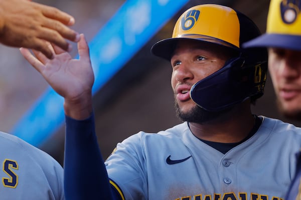 Milwaukee Brewers' Jackson Chourio celebrates after his run against the Minnesota Twins on a single by Christian Yelich in the sixth inning of a baseball game Friday, June 20, 2025, in Minneapolis. (AP Photo/Bruce Kluckhohn)