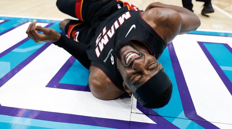 Miami Heat center Bam Adebayo (13) lies on the court during the first half of an NBA play-in tournament basketball game against the Charlotte Hornets in Charlotte, N.C., Tuesday, April 14, 2026. (AP Photo/Nell Redmond)