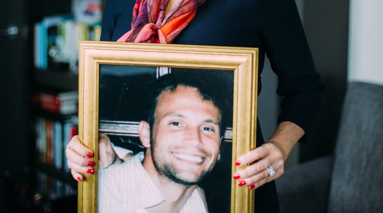 Cammie Wolf Rice holds a photo of her son, Christopher Wolf. Christopher died on Feb. 26, 2016, after a 14-year battle with opioid addiction. (Courtesy)