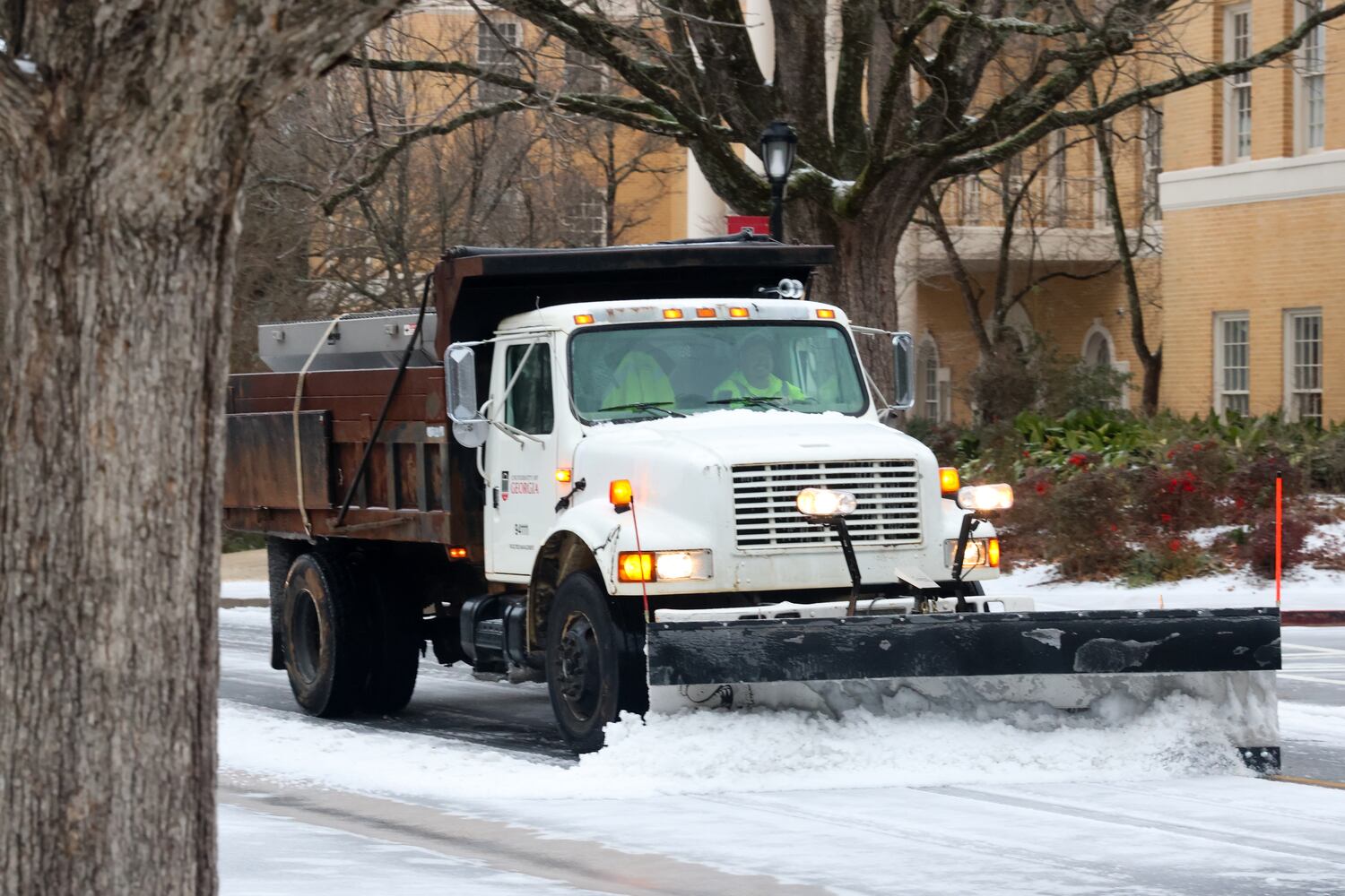 Workers clear snow on the UGA campus during the winter storm on Sunday morning, January 25, 2026. Students living in residence halls were encouraged to return home for the weekend if they were able. (C.J. Bartunek for the AJC)
