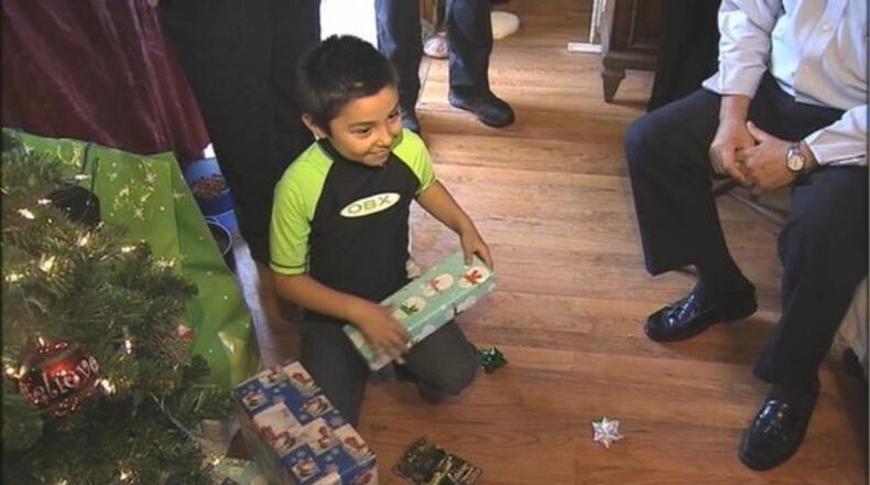 Scott Heavner received gifts from sheriff's deputies as Christmas arrived early for the 8-year-old boy.