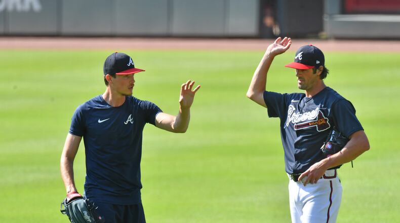 Braves pitchers Max Fried (left) and Cole Hamels talk during a workout in early July.