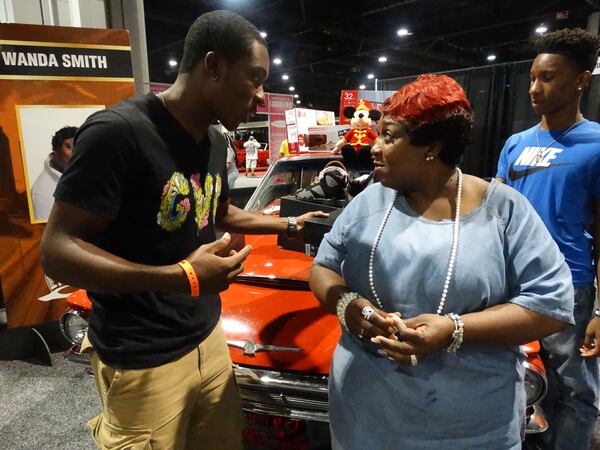 Wanda Smith with her 18-year-old son Giovanni, who has grown up on the radio and loves it. CREDIT: Rodney Ho/rho@ajc.com