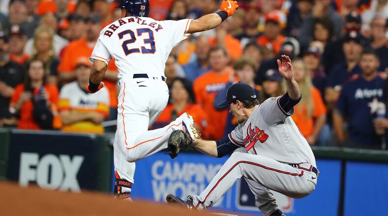 110221 HOUSTON: Braves starting and winning pitcher Max Fried falls after colliding with Astros Michael Brantley while fielding at first base in game 6 of the World Series on Tuesday, Nov. 2, 2021, in Houston. “Curtis Compton / Curtis.Compton@ajc.com”