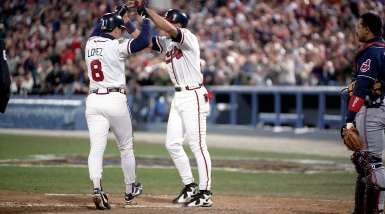 Javy Lopez (8) celebrates his sixth-inning home run at the plate with teammate David Justice in Game 2 of the World Series Oct. 22, 1995, in Atlanta.  (Frank Neimeir/AJC)