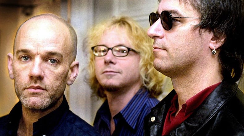 From left, Michael Stipe, Mike Mills and Peter Buck of R.E.M. pose for media during a photocall in London on April 27, 2001. (Odd Andersen/AFP via Getty Images/TNS)