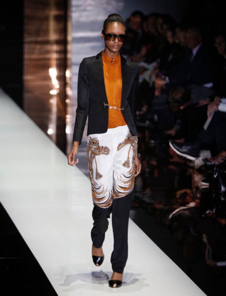 Models take the catwalk during Milan Fashion Week 2011