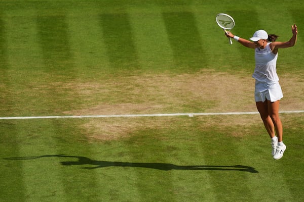 Iga Swiatek of Poland celebrates winning the women's singles final match against Amanda Anisimova of the U.S. at the Wimbledon Tennis Championships in London, Saturday, July 12, 2025.(AP Photo/Joanna Chan)