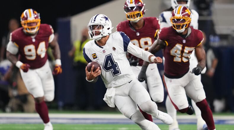 Dallas Cowboys quarterback Dak Prescott (4) runs against the Washington Commanders in the second half during an NFL football game in Arlington, Texas, Sunday, Sept. 20, 2026. (AP Photo/Tony Gutierrez)