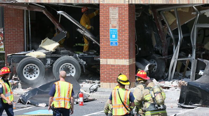 An unidentified driver of a tractor/trailer died Wednesday morning after his vehicle inexplicably plowed into a Lawrenceville strip mall.