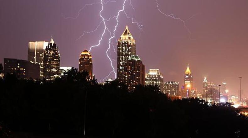 Lightning strikes behind the Atlanta skyline in a 2020 photo. A teenager swimming off Tybee Island is among the first two people killed by lightning this year in the U.S.