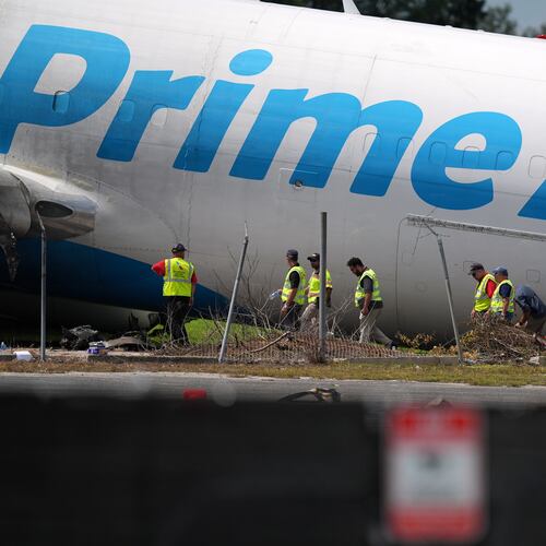 Workers inspect an Amazon cargo plane two days after it overshot a runway at Miami International Airport, Tuesday, Sept. 8, 2026, in Miami. (AP Photo/Rebecca Blackwell)