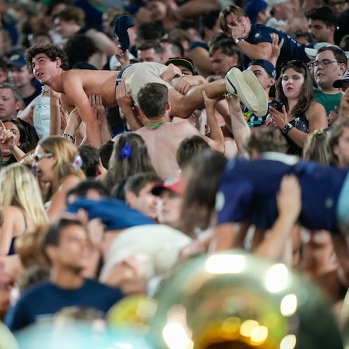 Notre Dame fans celebrate scoring a touchdown with pushups during the second half of an NCAA college football game against Wisconsin Sunday, Sept. 6, 2026, in Green Bay, Wis. (AP Photo/Kayla Wolf)