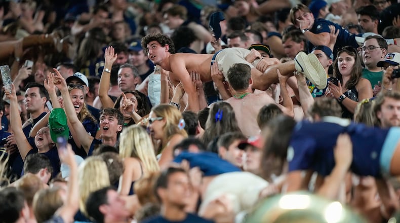 Notre Dame fans celebrate scoring a touchdown with pushups during the second half of an NCAA college football game against Wisconsin Sunday, Sept. 6, 2026, in Green Bay, Wis. (AP Photo/Kayla Wolf)